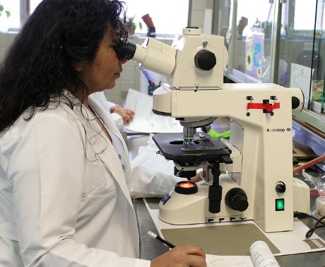 female scientist with microscope